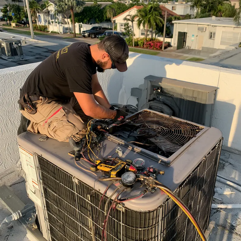 Technician testing an outdoor condenser with a multimeter and gauges after removing its fan grille
